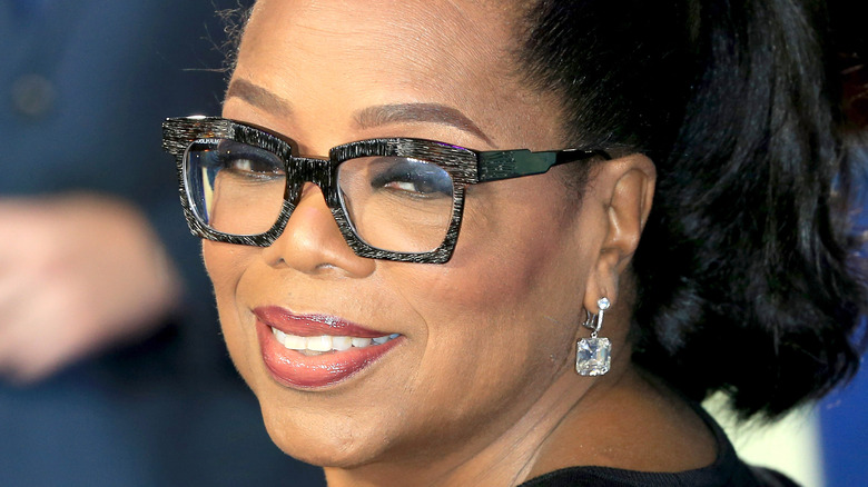 Oprah Winfrey smiling over her shoulder