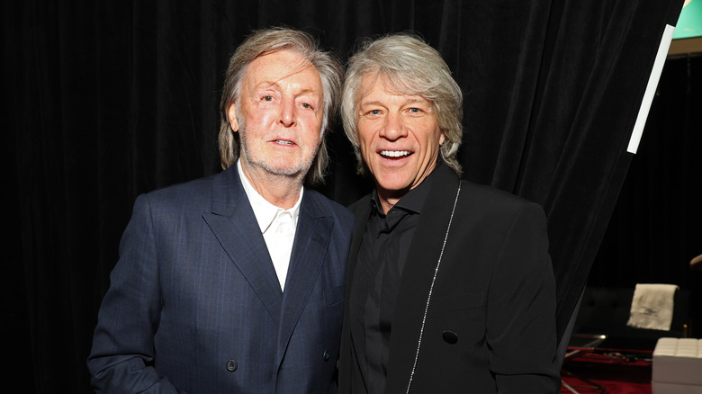 Paul McCartney and Jon Bon Jovi posing and smiling together