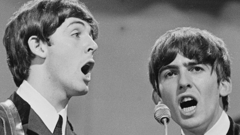 Vintage photo of George Harrison and Paul McCartney performing