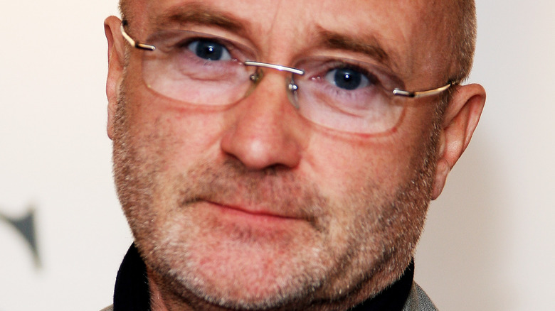 Phil Collins poses at an event.