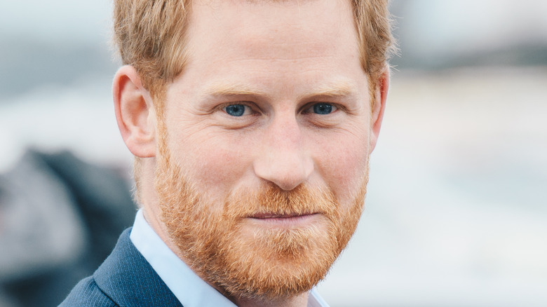 Prince Harry grinning with facial hair