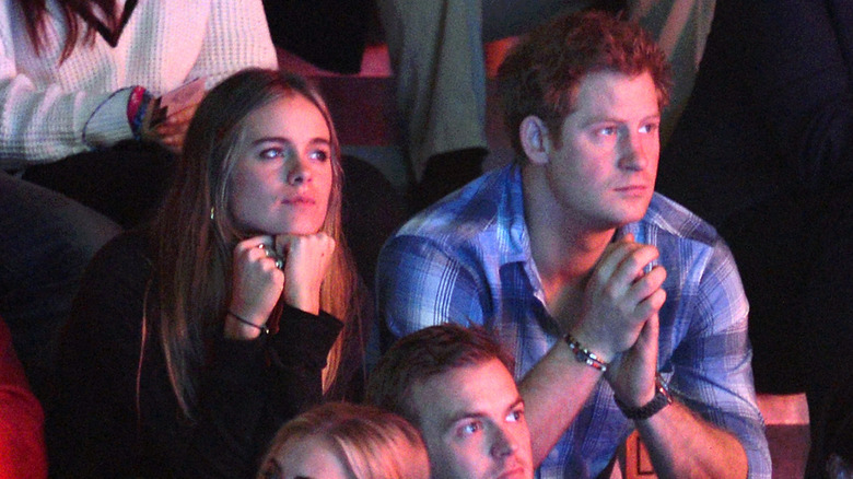 Prince Harry and Cressida Bonas sitting next to each other