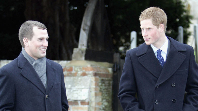 A young Peter Phillips and Prince Harry walking together