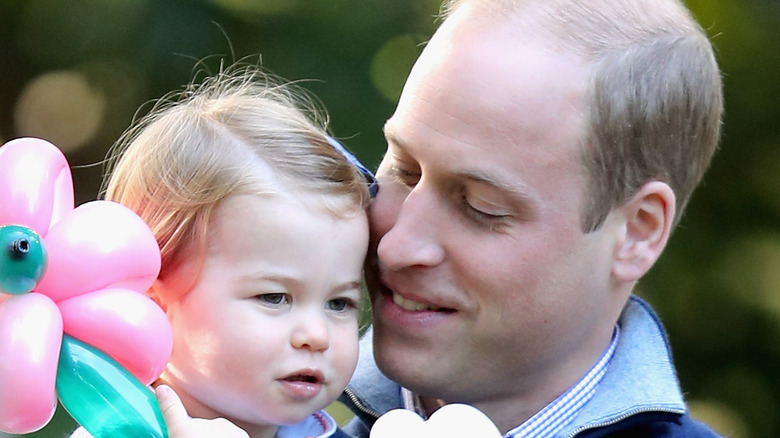 Prince William holding Princess Charlotte