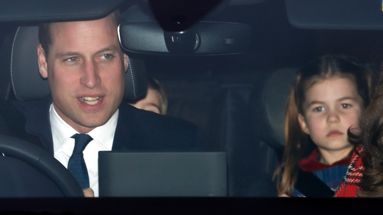 Prince William sitting in a car with Charlotte