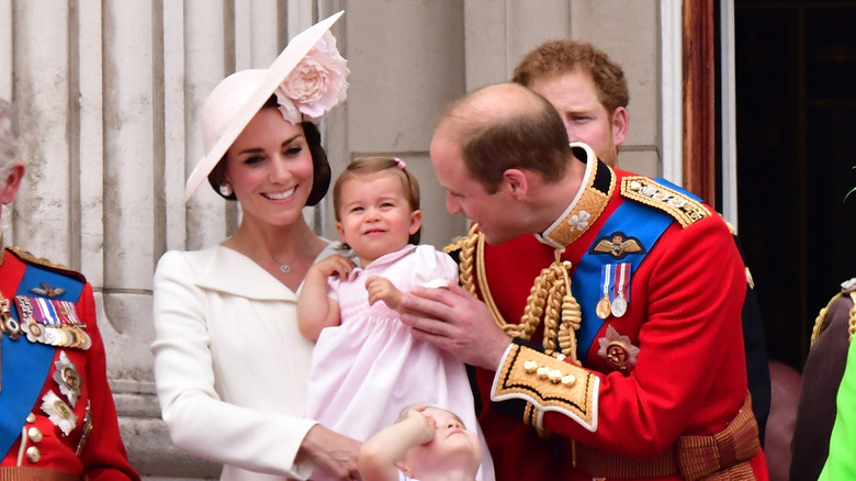Prince William holding Charlotte's hand