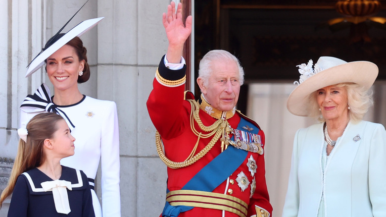 Princess Charlotte looking up at her grandfather, King Charles