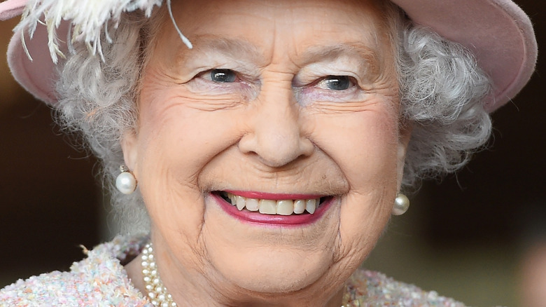 Queen Elizabeth smiling in pink