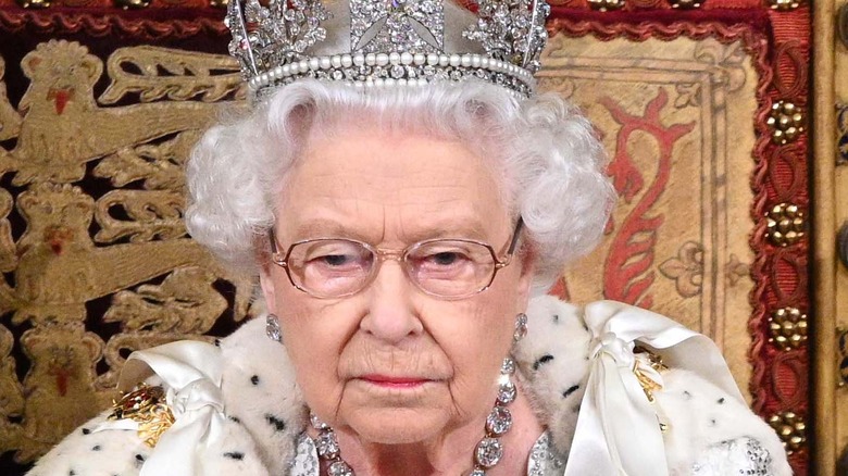 Prince Charles and Queen Elizabeth sitting on throne