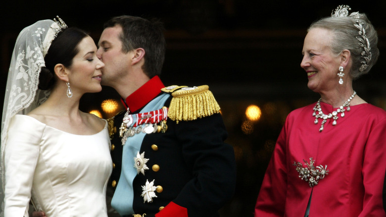 Queen Margrethe beams as her son kissed Mary on their wedding day
