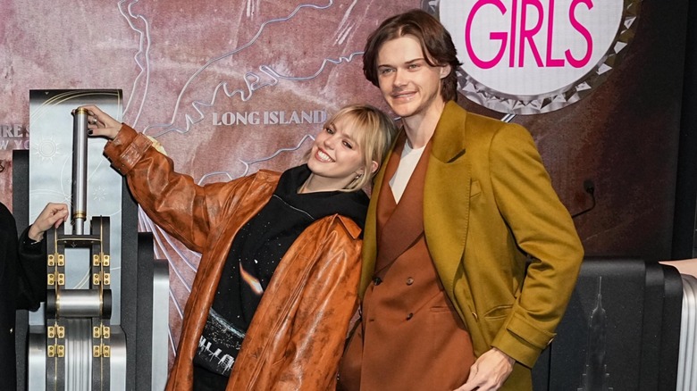 Reneé Rapp leaning on Christopher Briney, smiling