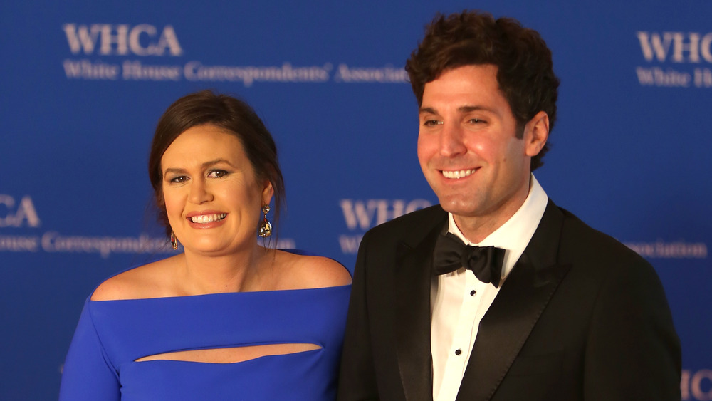 Sarah Huckabee Sanders and husband Bryan Sanders smiling on the red carpet