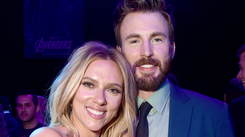 Scarlett Johansson and Chris Evans standing together