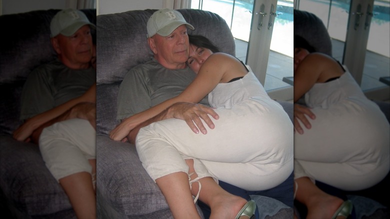 Bruce Willis holding his daughter, Scout Willis, in a recliner chair