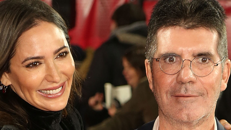 Lauren Silverman puts her arm around Simon Cowell.