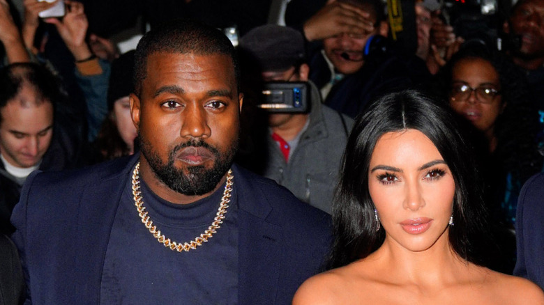 Kanye West and Kim Kardashian posing together at an event