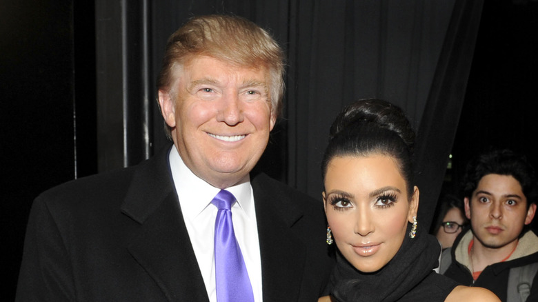 Donald Trump and Kim Kardashian posing for photos in 2010