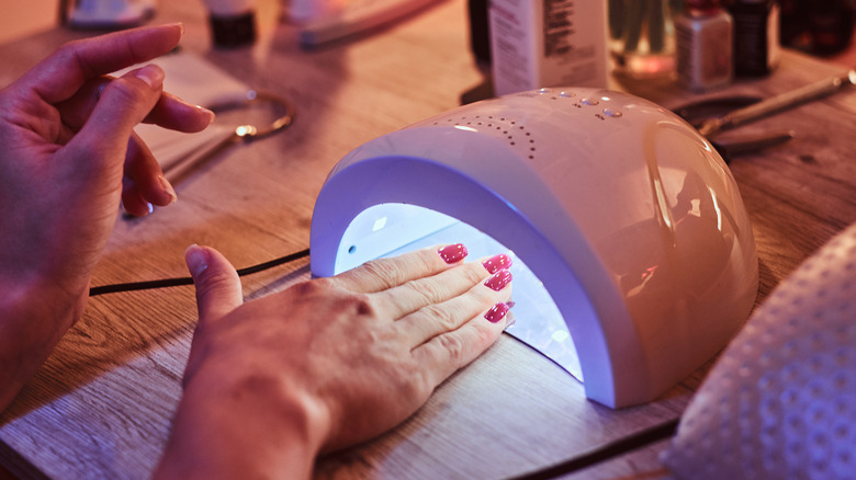 Nails drying under a UV dryer