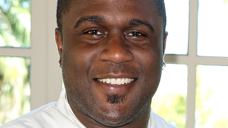 Cliff Crooks smiles with hoop earrings.