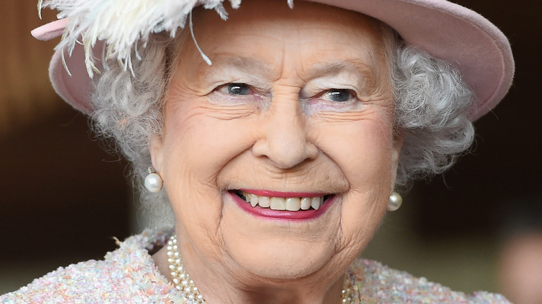 Queen Elizabeth smiling in pink