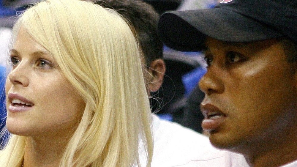 Tiger Woods sitting next to Elin Nordegren