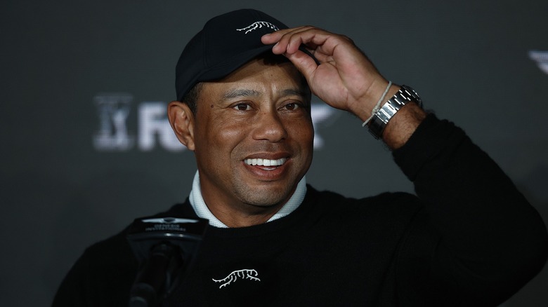 Tiger Woods tipping his baseball cap