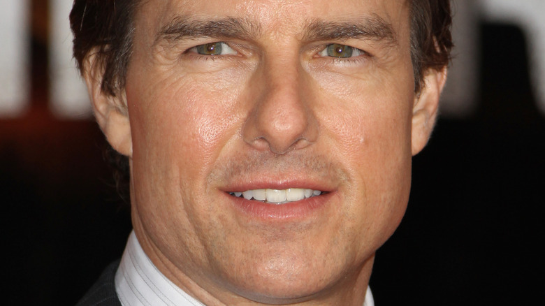 Tom Cruise attending and event and smiling