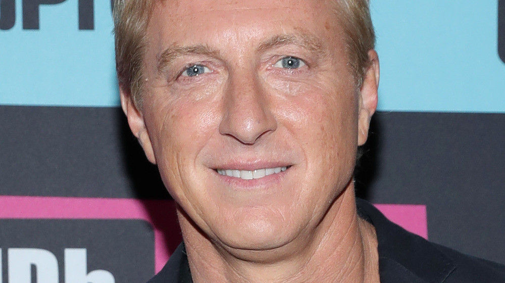 William Zabka posing and smiling