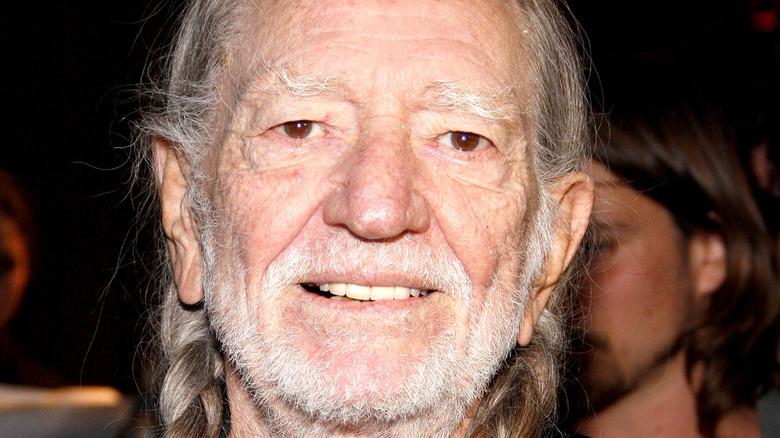 Willie Nelson smiling with braids