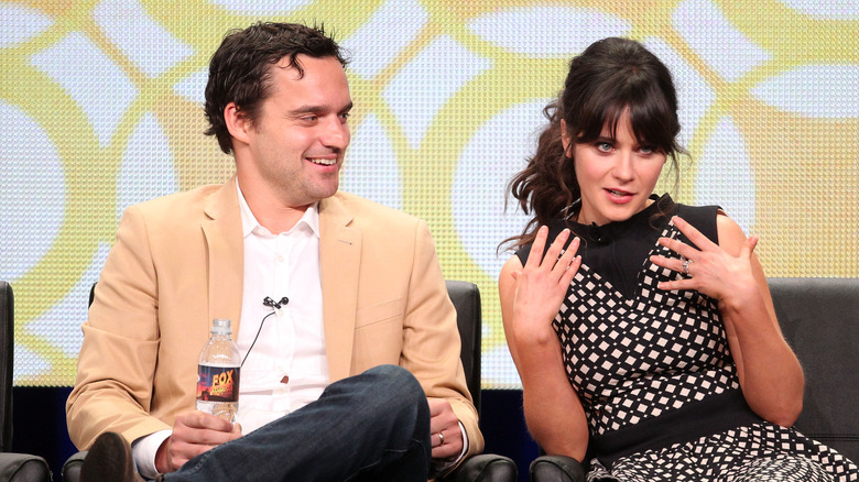 Nick Miller smiling at Zooey Deschanel as she's talking