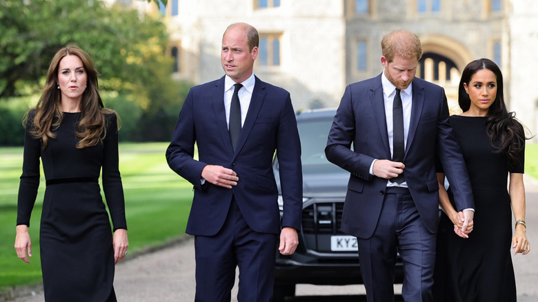Kate Middleton, Prince William, Prince Harry, and Meghan Markle walking outside of Windsor Castle