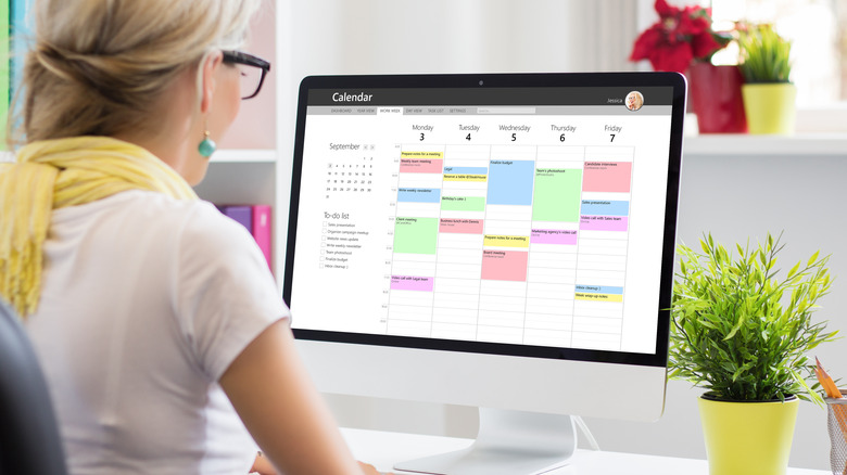 woman looking at schedule on computer