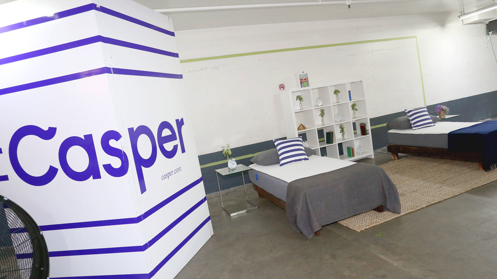 Casper box alongside two mattresses