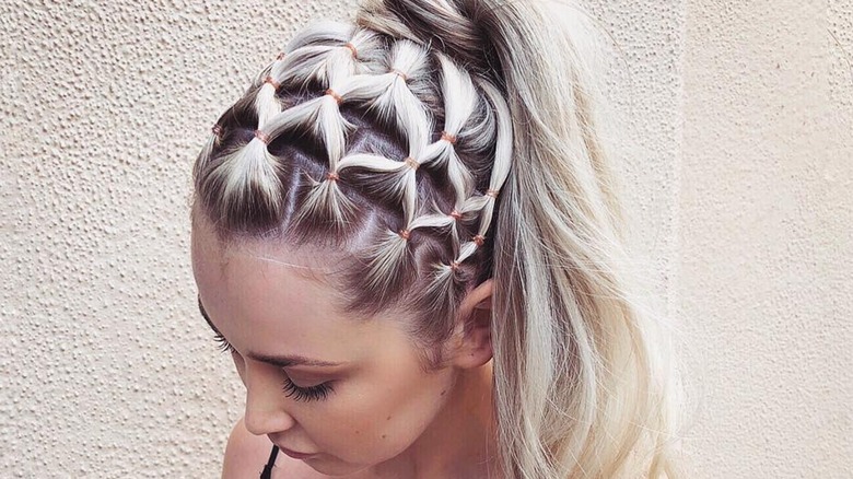 Woman with two small braids and hair elastics 