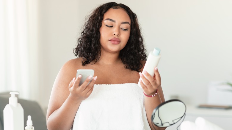 woman checking skincare ingredients on phone