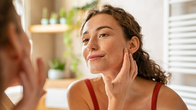 Woman touching face 