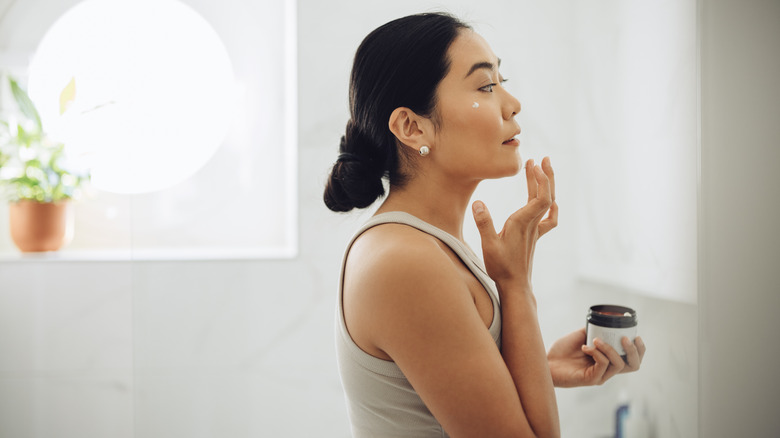 Woman applying skincare