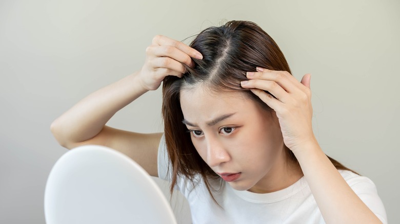 woman looking at her baby hairs