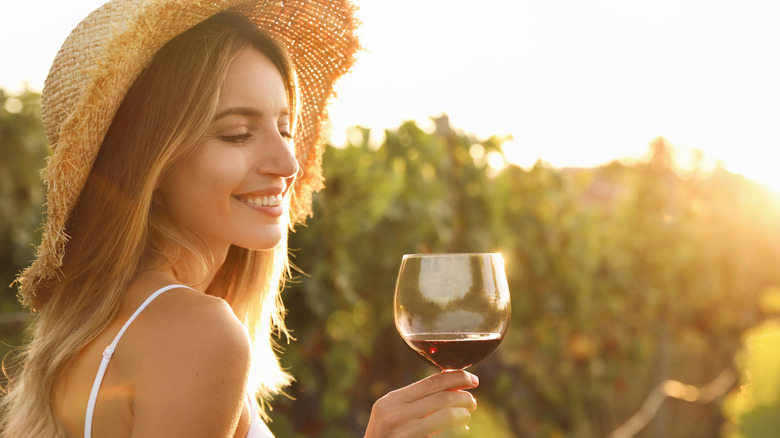 Woman holding glass of red wine