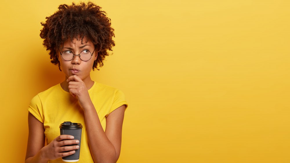 Woman contemplating coffee