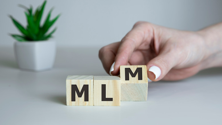 MLM spelled out in wooden blocks 