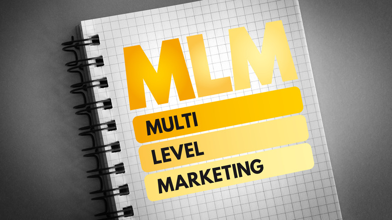 MLM spelled out in gold on a notebook 