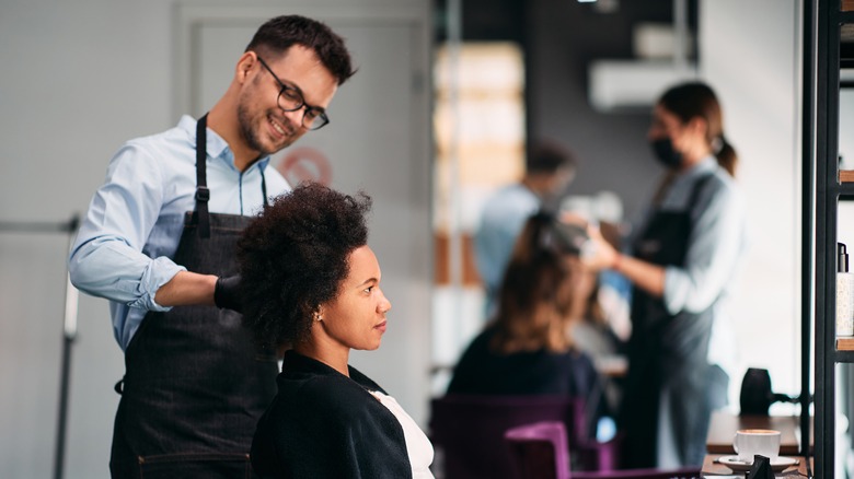 Stylist cutting client's hair