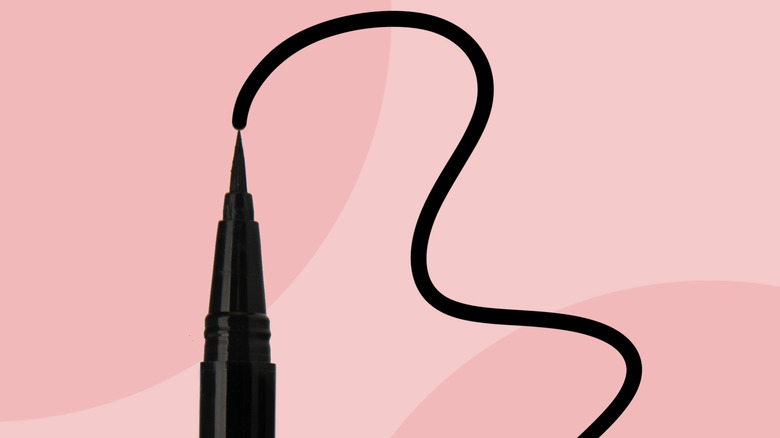 Liquid eyeliner pen drawing a line