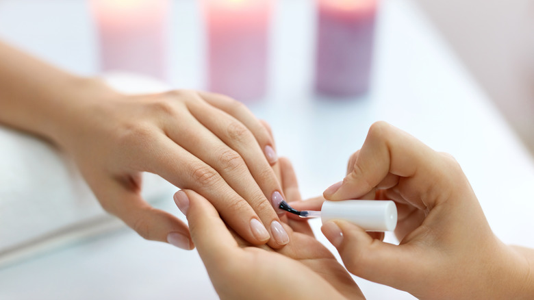 Woman having her nails painted