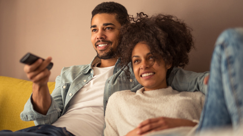 Couple enjoying movie date at home