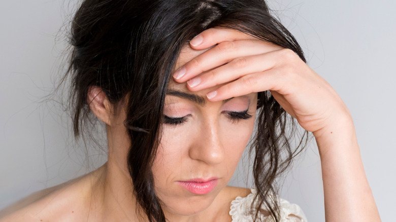 anxious bride with hand on forehead 