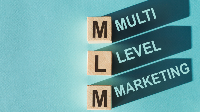 MLM spelled out in wooden tiles 