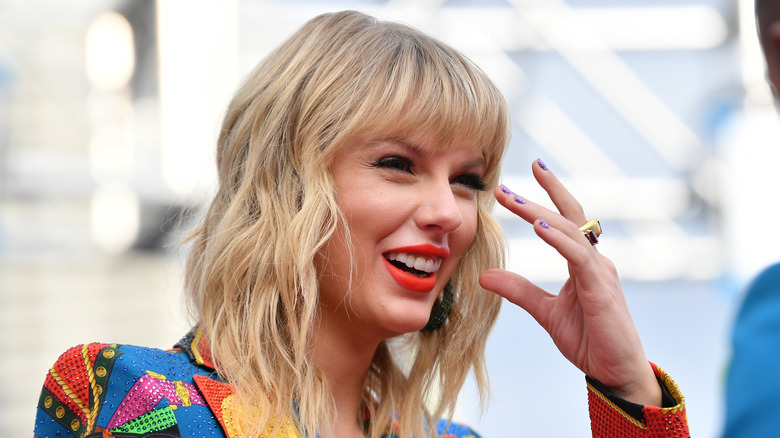Taylor Swift laughs on the red carpet
