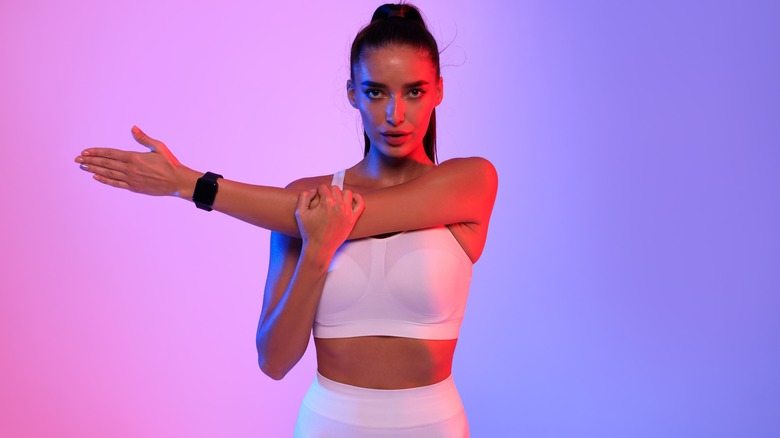 woman wearing smart watch stretching